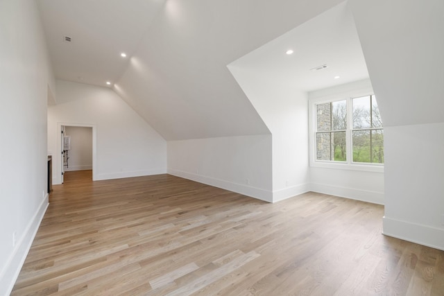 bonus room with vaulted ceiling, recessed lighting, baseboards, visible vents, and light wood-style flooring
