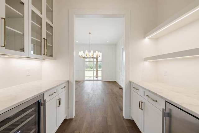 kitchen with beverage cooler, an inviting chandelier, white cabinetry, and open shelves