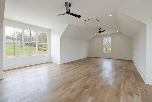bonus room featuring a ceiling fan, vaulted ceiling, baseboards, and light wood finished floors