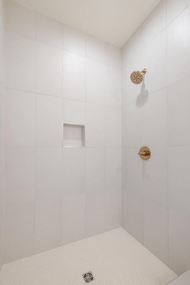 full bath with a tile shower
