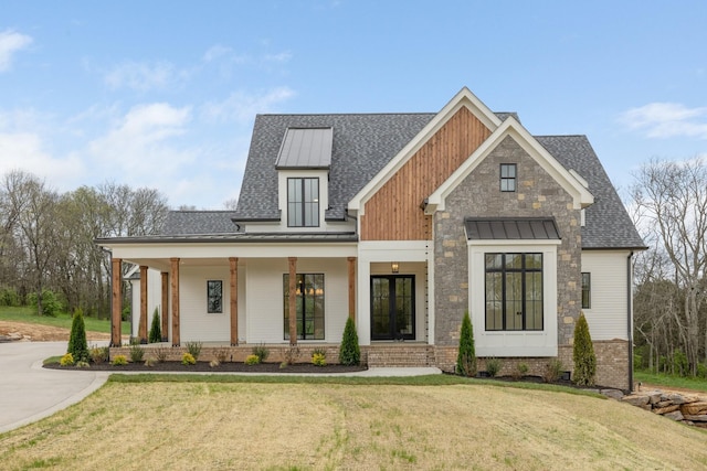 modern farmhouse with a front lawn, a shingled roof, a standing seam roof, and a porch