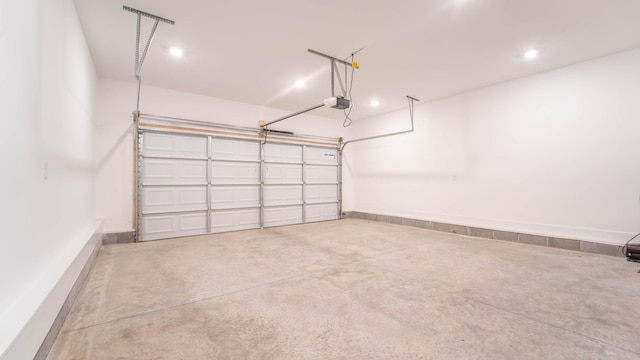 garage featuring recessed lighting and a garage door opener