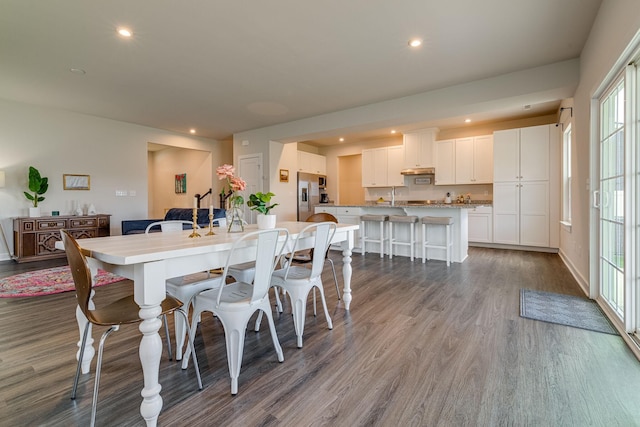 dining room featuring dark wood-type flooring, recessed lighting, and baseboards