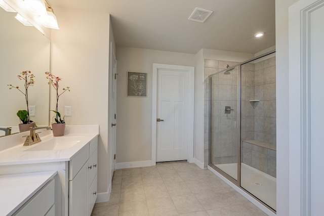 full bathroom with a stall shower, baseboards, visible vents, tile patterned flooring, and vanity