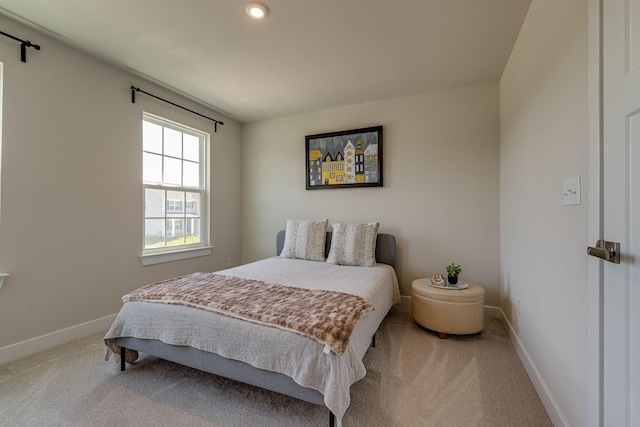 carpeted bedroom featuring baseboards