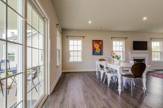 dining area with dark wood-type flooring, recessed lighting, and baseboards