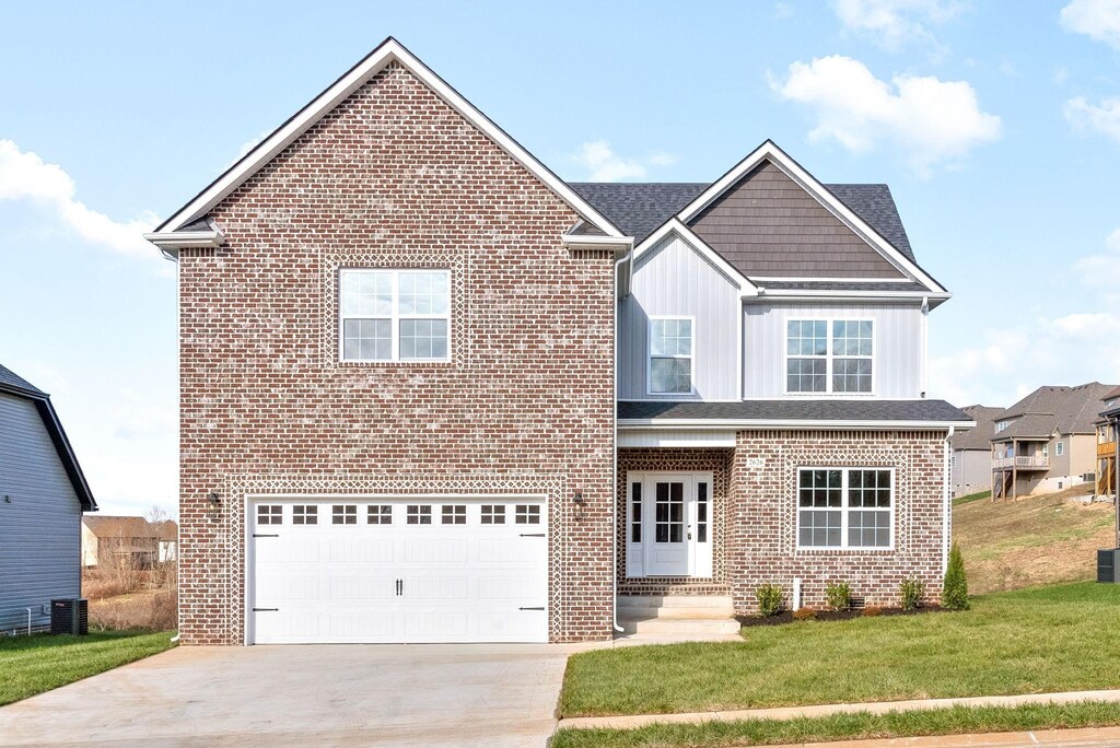 1196 Gardenia Ln, Clarksville, TN 37043 - traditional-style home featuring an attached garage, brick siding, concrete driveway, a front lawn, and board and batten siding