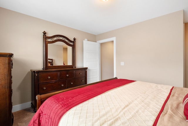 carpeted bedroom featuring baseboards