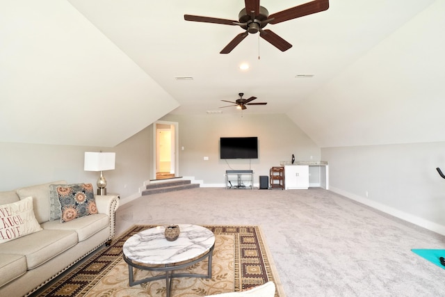 carpeted living room featuring lofted ceiling, visible vents, and baseboards