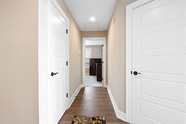 hallway featuring visible vents, baseboards, dark wood-type flooring, and recessed lighting