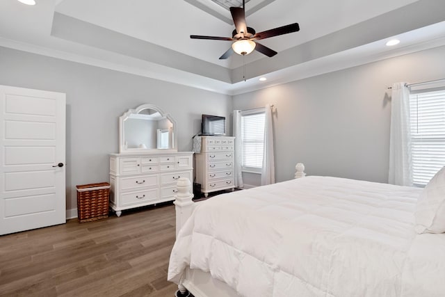 bedroom with a tray ceiling, crown molding, recessed lighting, ceiling fan, and wood finished floors