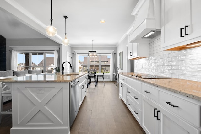 kitchen featuring a sink, black electric stovetop, custom exhaust hood, white cabinetry, and backsplash