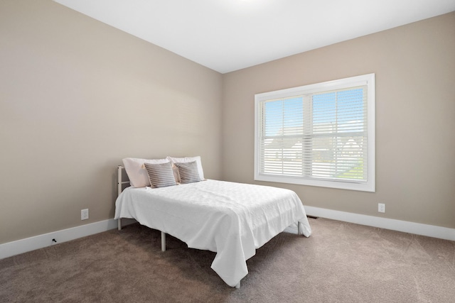 bedroom featuring baseboards and carpet flooring