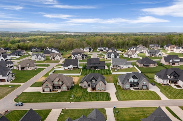 aerial view with a wooded view and a residential view