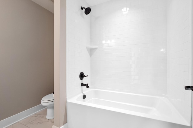 full bathroom featuring toilet, marble finish floor, washtub / shower combination, and baseboards