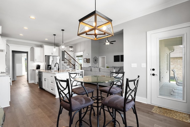 dining room featuring plenty of natural light, ornamental molding, and dark wood-type flooring