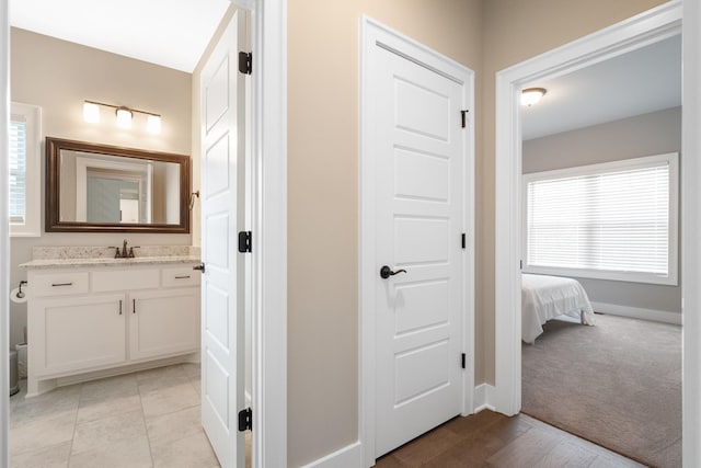 bathroom with tile patterned flooring, vanity, and baseboards