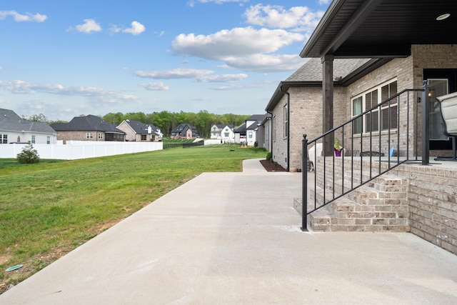 view of patio / terrace featuring a residential view and fence