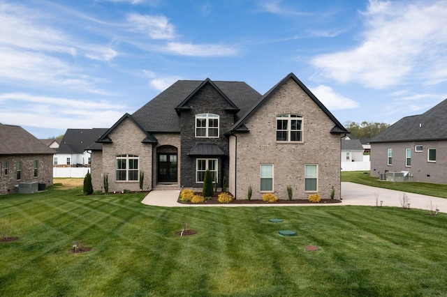 view of front of property with brick siding and a front yard