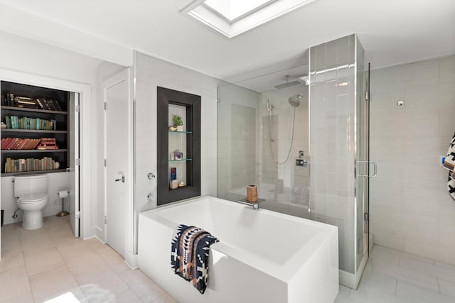 full bath featuring a garden tub, toilet, tile patterned flooring, a skylight, and a shower stall