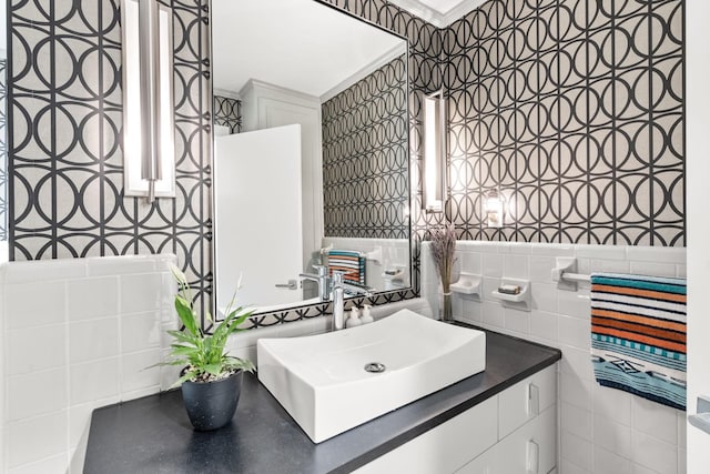 bathroom with ornamental molding, tile walls, and vanity