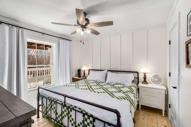 bedroom with light wood-style floors and a ceiling fan