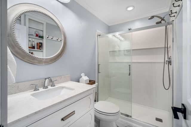 bathroom featuring toilet, a shower stall, and vanity