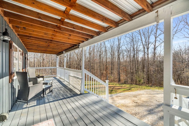 deck featuring outdoor lounge area and a view of trees