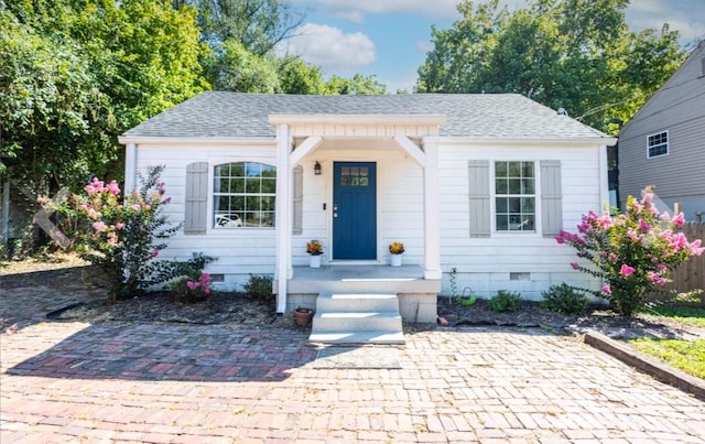 bungalow featuring a shingled roof and crawl space