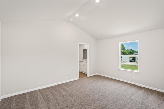 spare room featuring vaulted ceiling, recessed lighting, carpet flooring, and baseboards