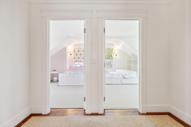 doorway to outside with baseboards and wood finished floors