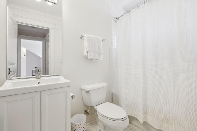 bathroom with vanity, toilet, and baseboards