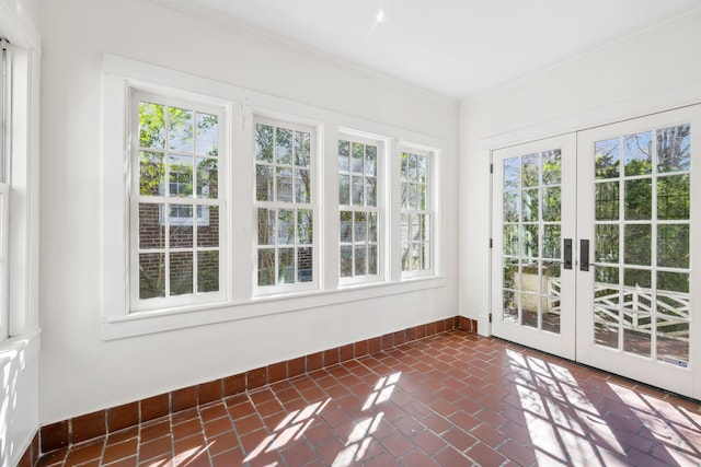 unfurnished sunroom featuring a healthy amount of sunlight and french doors