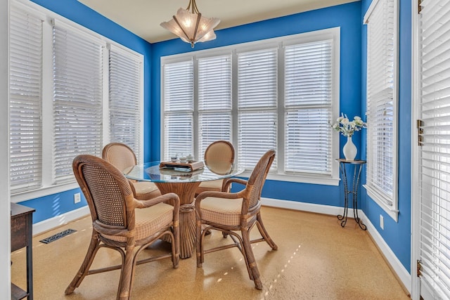 dining room with plenty of natural light, visible vents, baseboards, and carpet flooring