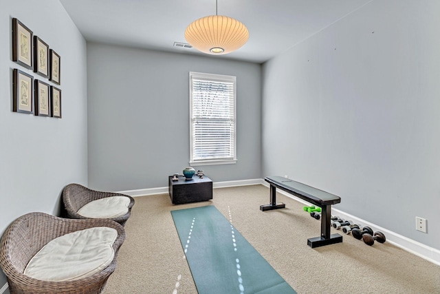 exercise room featuring carpet, visible vents, and baseboards