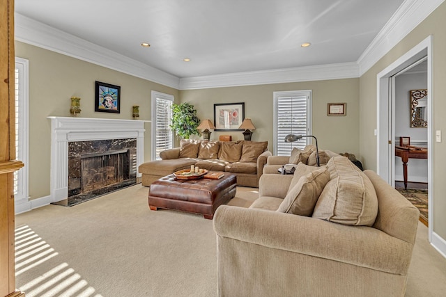 carpeted living area featuring baseboards, recessed lighting, a fireplace, and crown molding