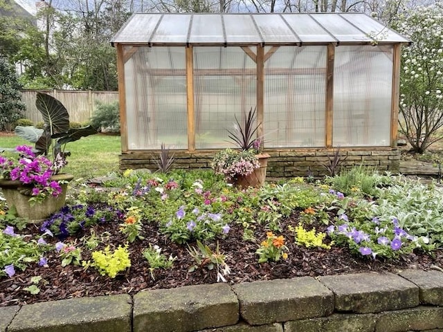 view of greenhouse with fence