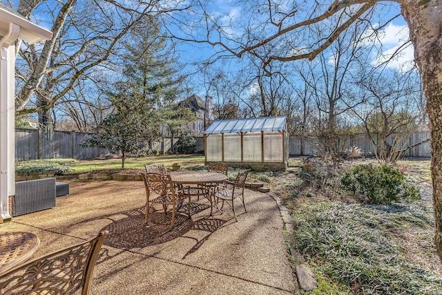 view of patio / terrace featuring an exterior structure, an outdoor structure, and a fenced backyard