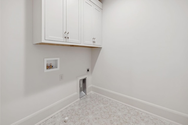 washroom featuring cabinet space, baseboards, tile patterned floors, hookup for a washing machine, and electric dryer hookup