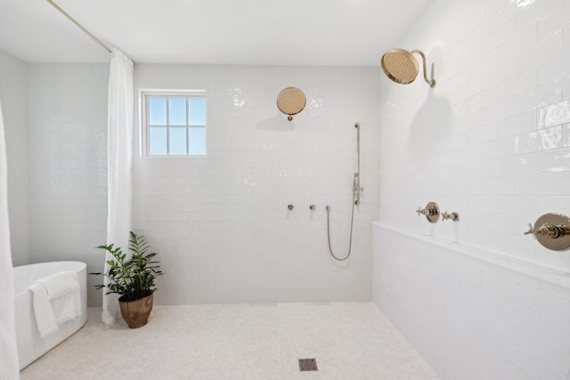 bathroom featuring tiled shower and a soaking tub