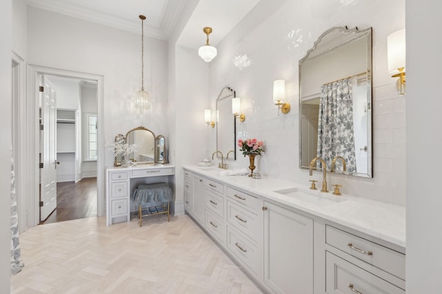 bathroom featuring double vanity, tasteful backsplash, a sink, and crown molding