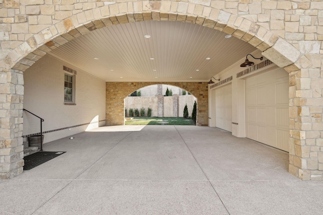 view of patio / terrace with a garage and driveway