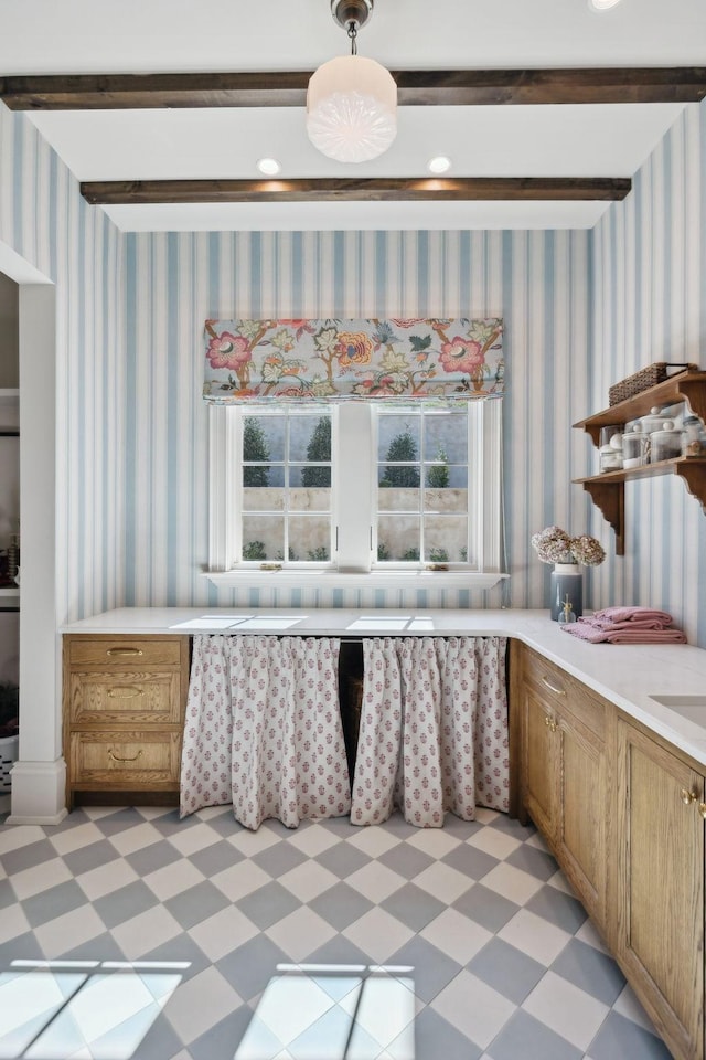 interior space featuring a wealth of natural light, light countertops, light floors, and wallpapered walls