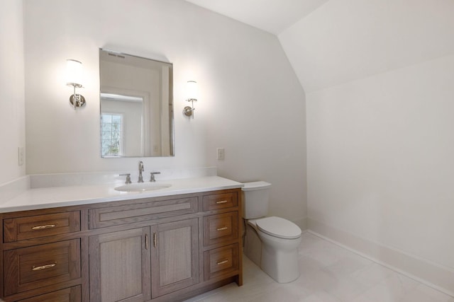 half bathroom featuring vaulted ceiling, vanity, toilet, and baseboards