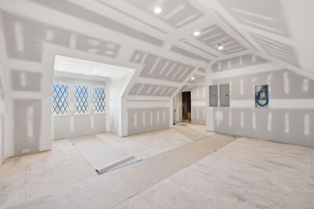 additional living space featuring electric panel and vaulted ceiling