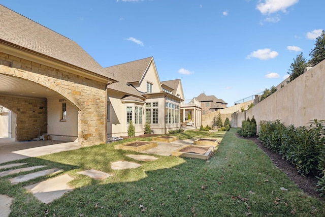 view of yard with a garden and a fenced backyard