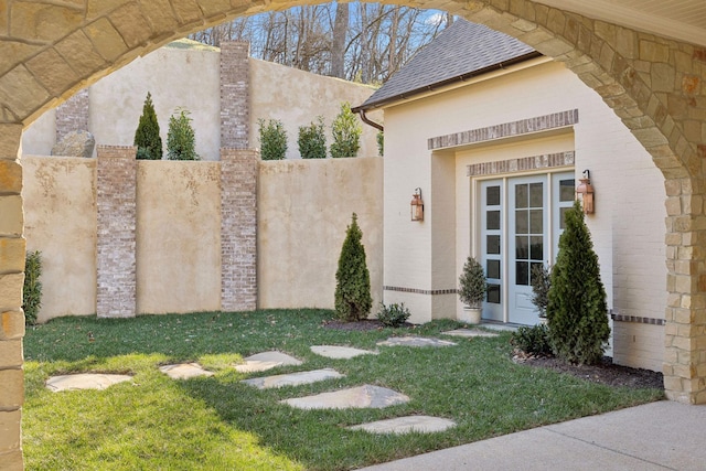 exterior space featuring french doors and fence