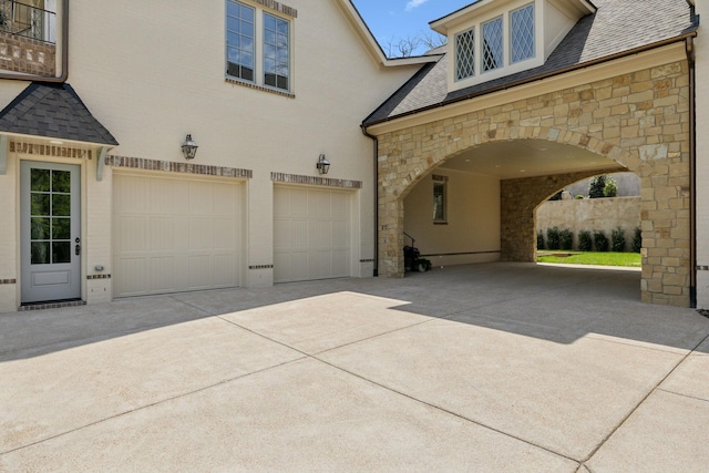 391 The Lady Of The Lake Ln, Franklin, TN 37067 - view of front facade with stone siding, concrete driveway, an attached garage, and roof with shingles