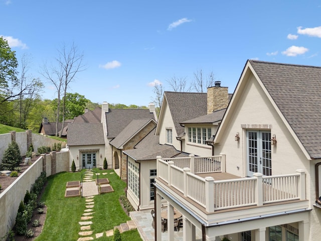 391 The Lady Of The Lake Ln, Franklin, TN 37067 - back of property with a shingled roof, a chimney, stucco siding, and french doors