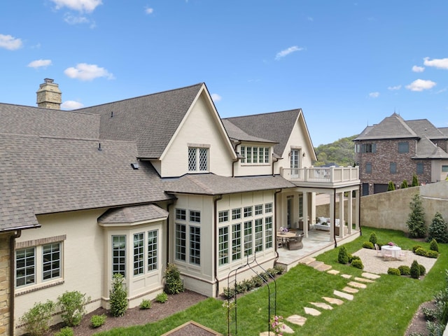 391 The Lady Of The Lake Ln, Franklin, TN 37067 - back of house with a balcony, roof with shingles, a patio, a fire pit, and a chimney